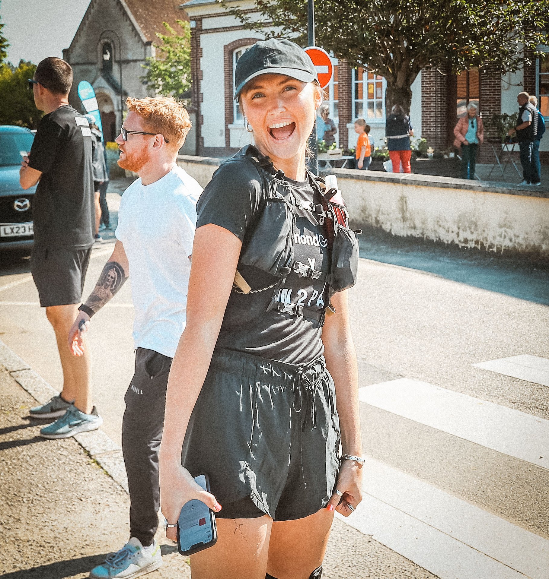 Bright female runner smiling during Run2Paris relay from London to Paris.