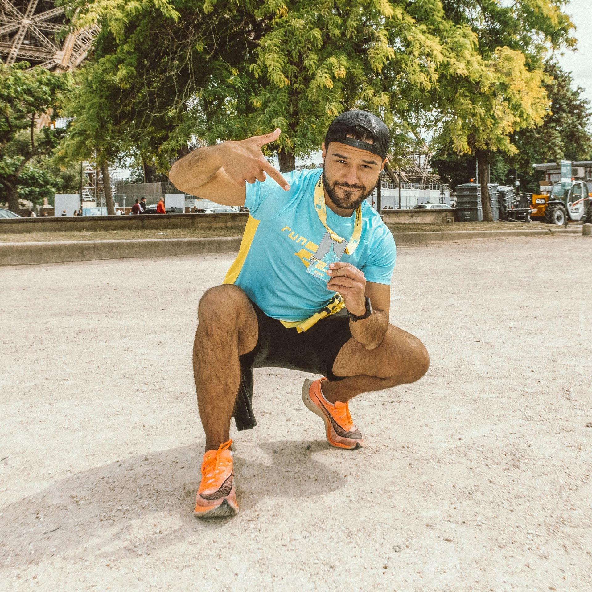 Runner celebrating at Run2Paris relay event, highlighting London to Paris marathon.