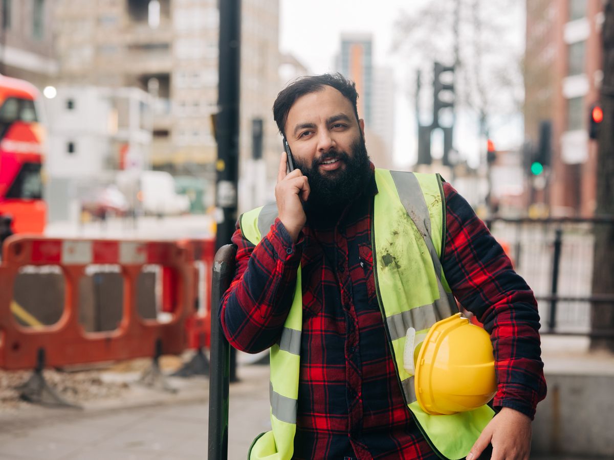 Man in high vis vest making a phone call