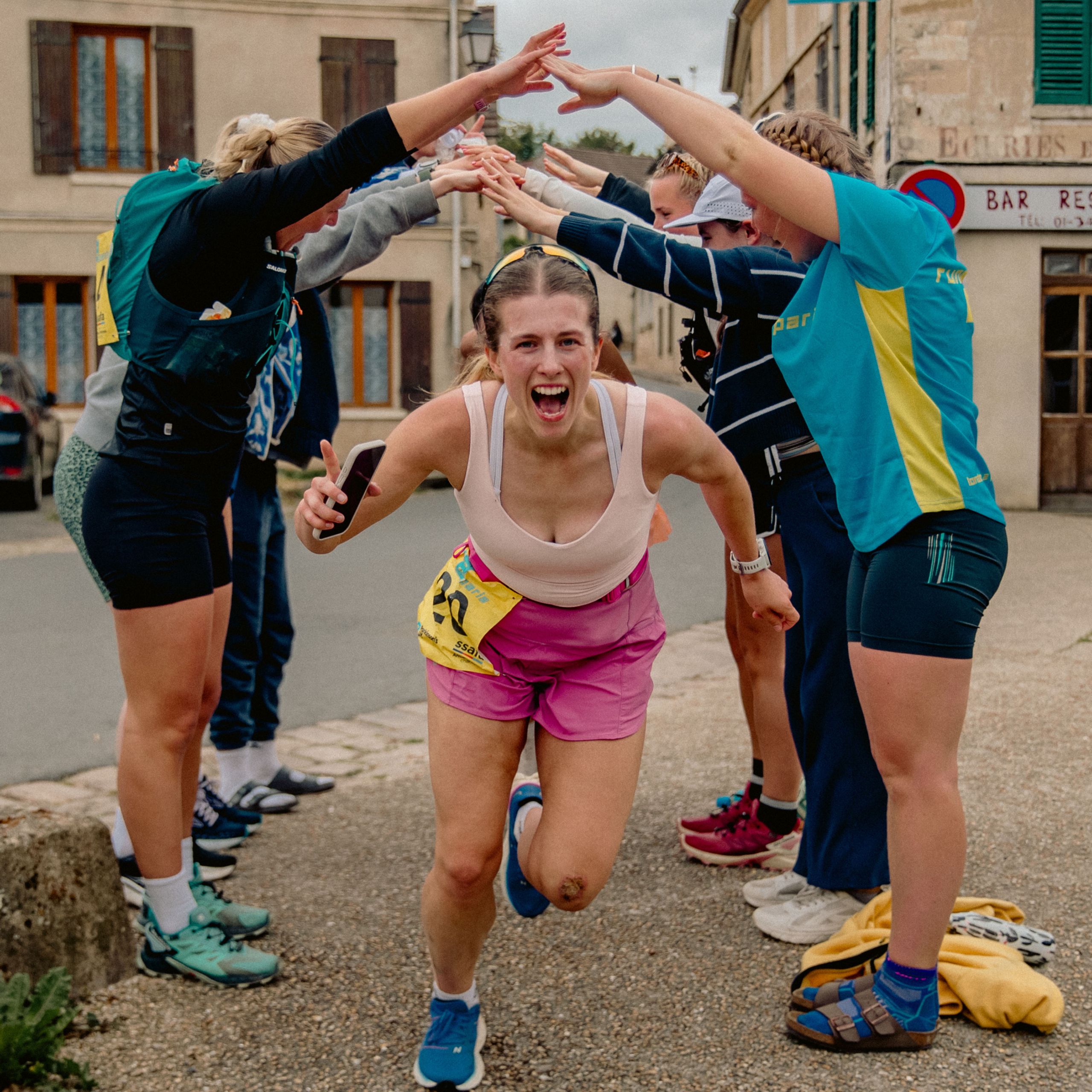 Energetic female runner celebrating during the relay run from London to Paris.