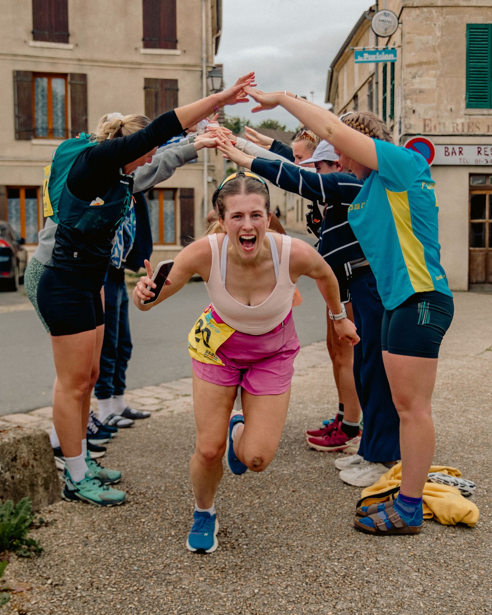 Energetic female runner celebrating during the relay run from London to Paris.