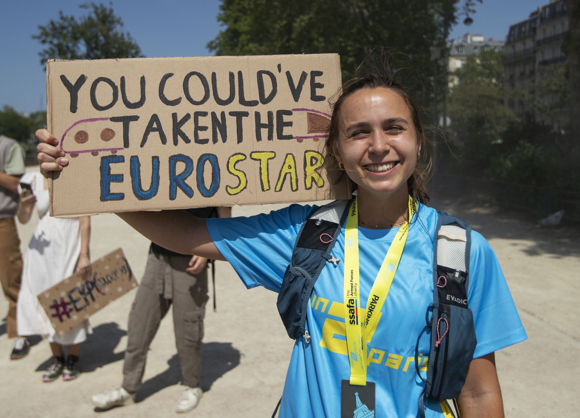 a woman holding a sign saying "You could've taken the EuroStar"