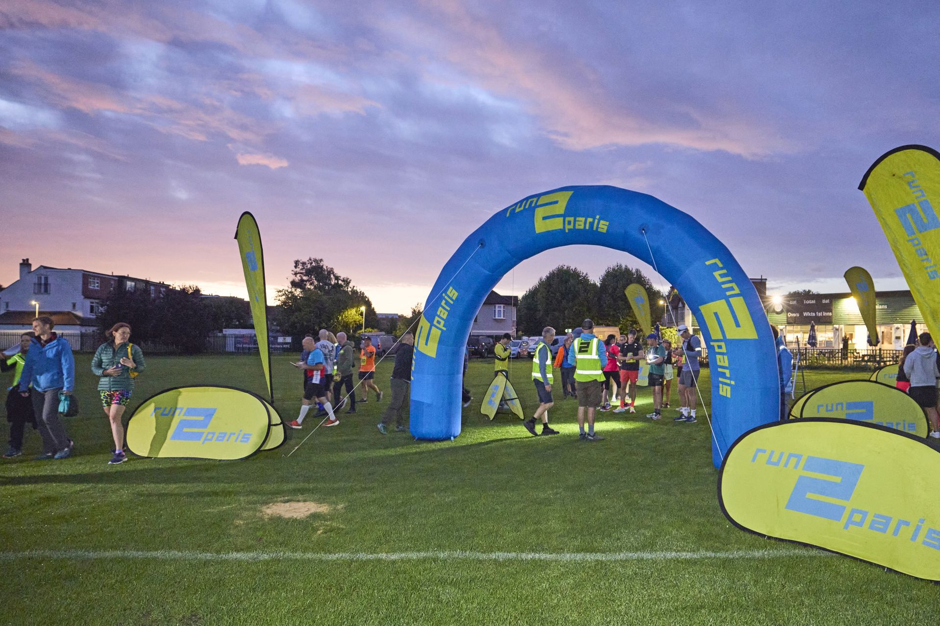 Running relay event from London to Paris at sunset.