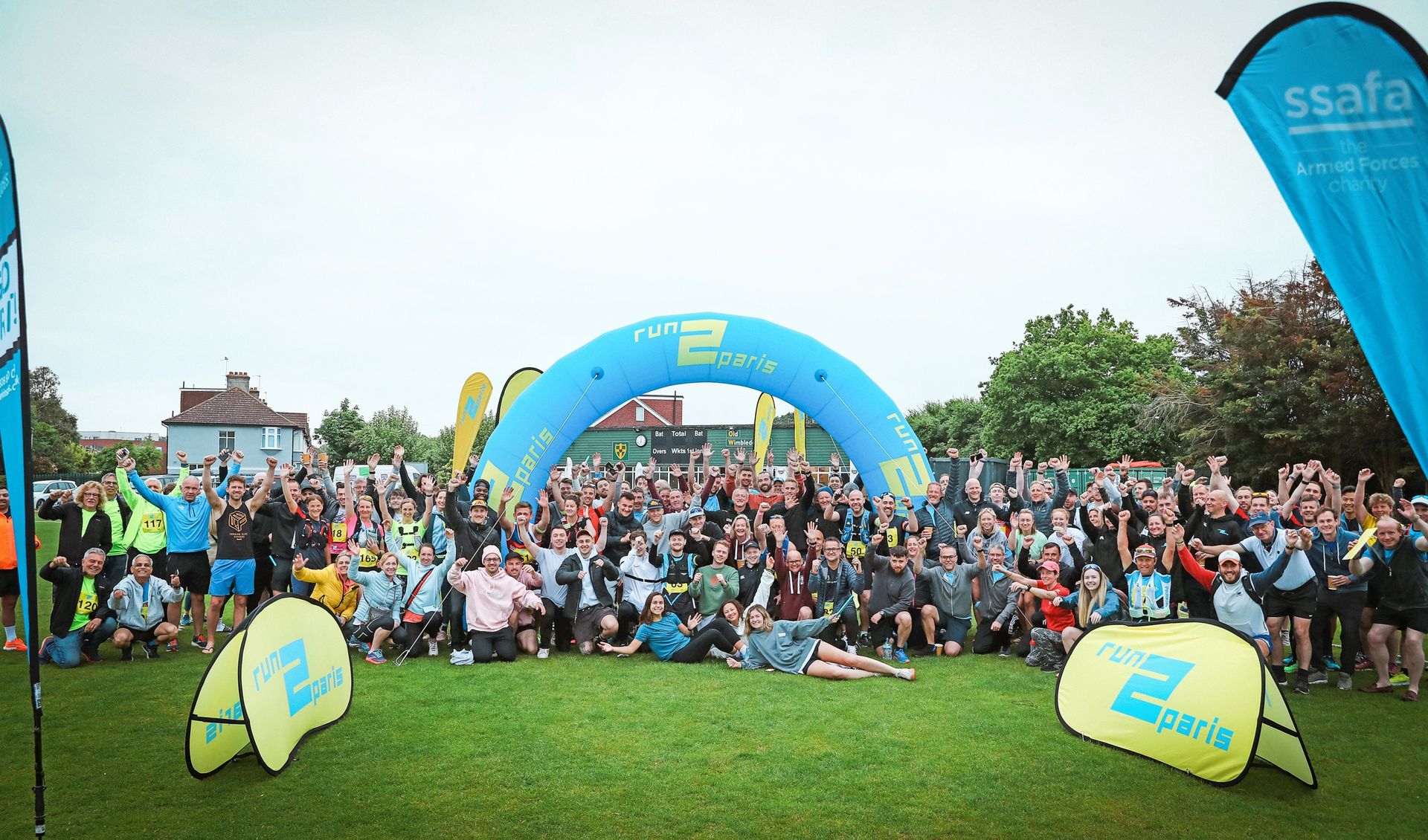 Vibrant group photo of runners at the start of the Run2Paris relay from London to Paris.